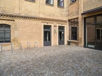 the entrance of a building on a cobblestone street in london, england stock photo