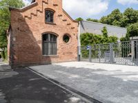 the brick building is very ornate and pretty, with an arched entrance to the side