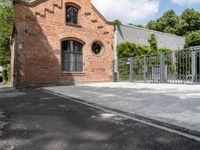 the brick building is very ornate and pretty, with an arched entrance to the side