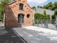 the brick building is very ornate and pretty, with an arched entrance to the side