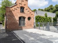 the brick building is very ornate and pretty, with an arched entrance to the side