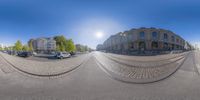 there is a fish eye lens of an empty street in the city of europe, taken with the fisheye lens