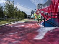 a building painted with colorful street art in red, blue, and green colors is shown