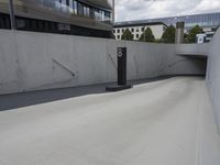 a skateboarder is doing tricks down a ramp at the skate park in an urban setting
