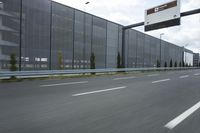 an industrial building with large outdoor advertising on the side of it, along with a bicycle next to it