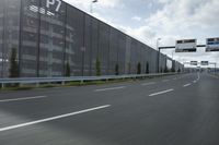 an industrial building with large outdoor advertising on the side of it, along with a bicycle next to it