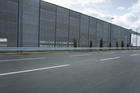 an industrial building with large outdoor advertising on the side of it, along with a bicycle next to it