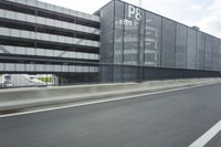 an industrial building with large outdoor advertising on the side of it, along with a bicycle next to it