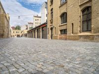 a cobble - stone road is empty in the city of edinburgh, scotland, but not very scenic