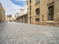 a cobble - stone road is empty in the city of edinburgh, scotland, but not very scenic