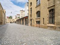 a cobble - stone road is empty in the city of edinburgh, scotland, but not very scenic