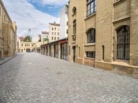 a cobble - stone road is empty in the city of edinburgh, scotland, but not very scenic