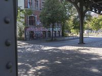 a view from the window of an empty train platform with graffiti on it's side