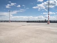 a empty parking lot with an orange traffic cone and red cones on top of it