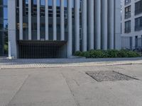 the side of a building with trees on either side and other bushes on the other side