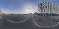 a street with a traffic light and buildings in the background, taken from a spherical mirror