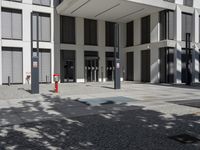 a very tall building with black shutters and glass windows on the front of it