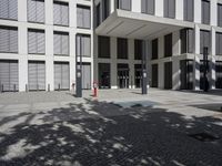 a very tall building with black shutters and glass windows on the front of it