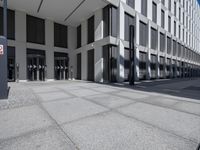 a very tall building with black shutters and glass windows on the front of it