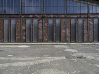 a man is standing in front of an empty building with no doors in it,