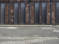 a man is standing in front of an empty building with no doors in it,