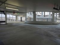 a big empty parking garage with concrete floors and walls on either side of the building