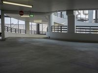 a big empty parking garage with concrete floors and walls on either side of the building