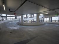 a big empty parking garage with concrete floors and walls on either side of the building
