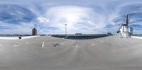 the view from above an empty parking lot with buildings in the distance, and there are no cars