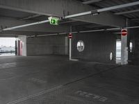 a picture of the inside of a large building, which is empty and has only one exit sign