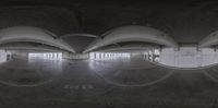 a big building with three mirrors and the floor still covered in graffiti on the floor