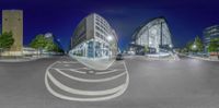 this is a view from inside a spherical perspective of the city at night time in perspective to the modern architecture of the buildings, people are walking along the street and the walkways