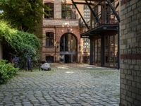 a courtyard with a patio and a fire place and a bench on the ground of the street