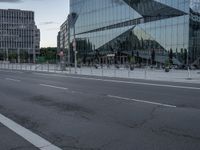 street scene with buildings and a parking meter in front of a glassy building on the side of the highway