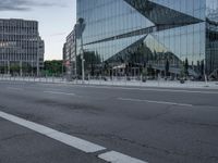 street scene with buildings and a parking meter in front of a glassy building on the side of the highway