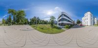 a fish eye lens with two buildings in the background and one is on the ground