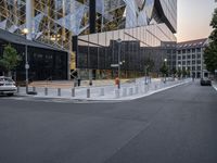 an intersection with a view of a modern building at sunset or dawn in a european city