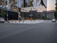 an intersection with a view of a modern building at sunset or dawn in a european city