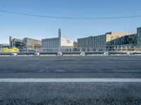 the street is empty and there are some benches along with buildings in the background for example,