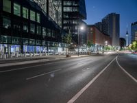 a street view with a building in the background at dusk with no cars on the street