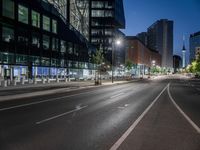 a street view with a building in the background at dusk with no cars on the street