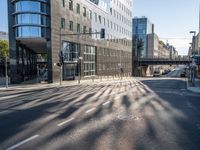 a big building with a tall, glassy structure in it and there is an exit sign on the sidewalk