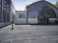 a parking meter is located in front of the building and looks out at the outdoors