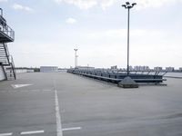 a boat is parked in an empty parking lot near an air port on the water