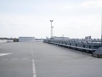 a boat is parked in an empty parking lot near an air port on the water