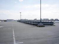 a boat is parked in an empty parking lot near an air port on the water