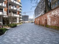 there is an alley way that is well paved by building on both sides and the street