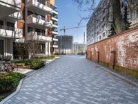 there is an alley way that is well paved by building on both sides and the street