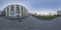 the panoramic image is of a park and building complex in europe from a 360 camera