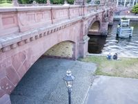 a brick bridge with two old lamps and an ornately decorated design on the side of the bridge